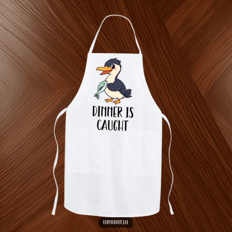 Funny cormorant apron depicting a smiling bird proudly holding a shiny fish in its beak, ideal for kitchen pride.