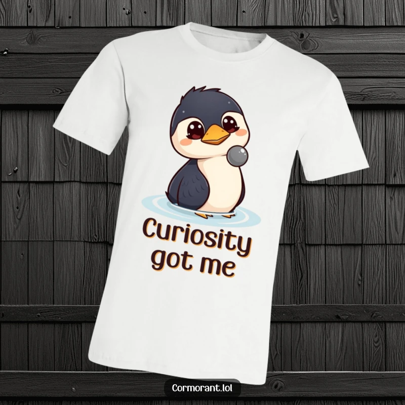 Funny kawaii cormorant t-shirt featuring a bird with wide, curious eyes intently watching a floating object, conveying thoughtfulness.
