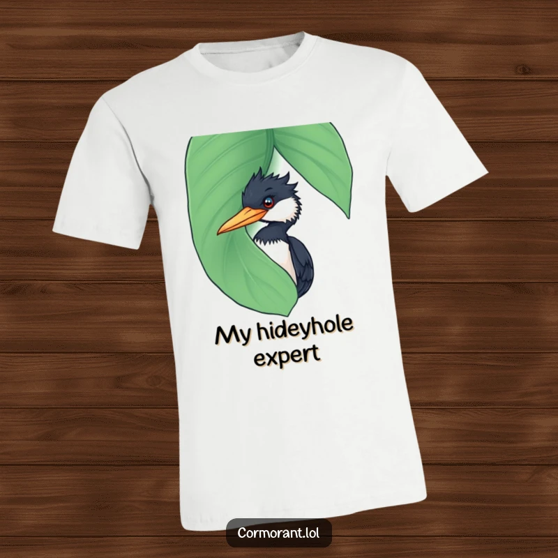 Funny Cormorant T-Shirt: A comical cormorant peeking slyly from behind a large, wet leaf, highlighting its curious and funny nature.
